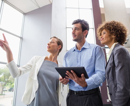 Business executives discussing over digital tablet